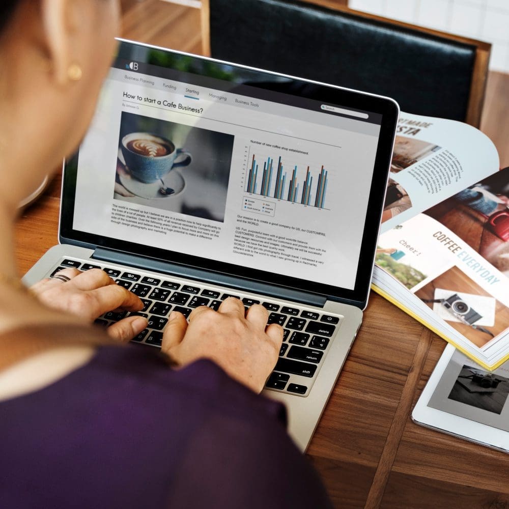 A woman utilizing a laptop for local search engine optimization.