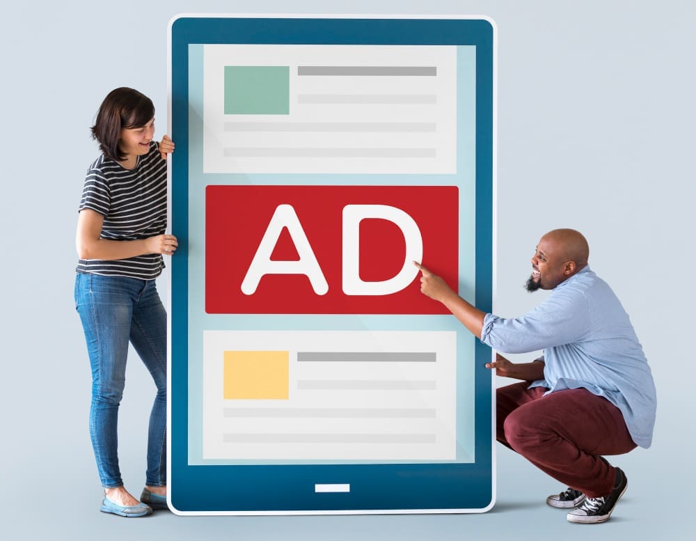 Two individuals examining a massive screen displaying an ad.